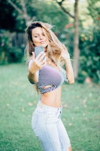 Blogger filming in nature for fashion blog