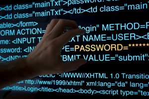 In the dark, a hacker tries to steal a password from a HTML logon script